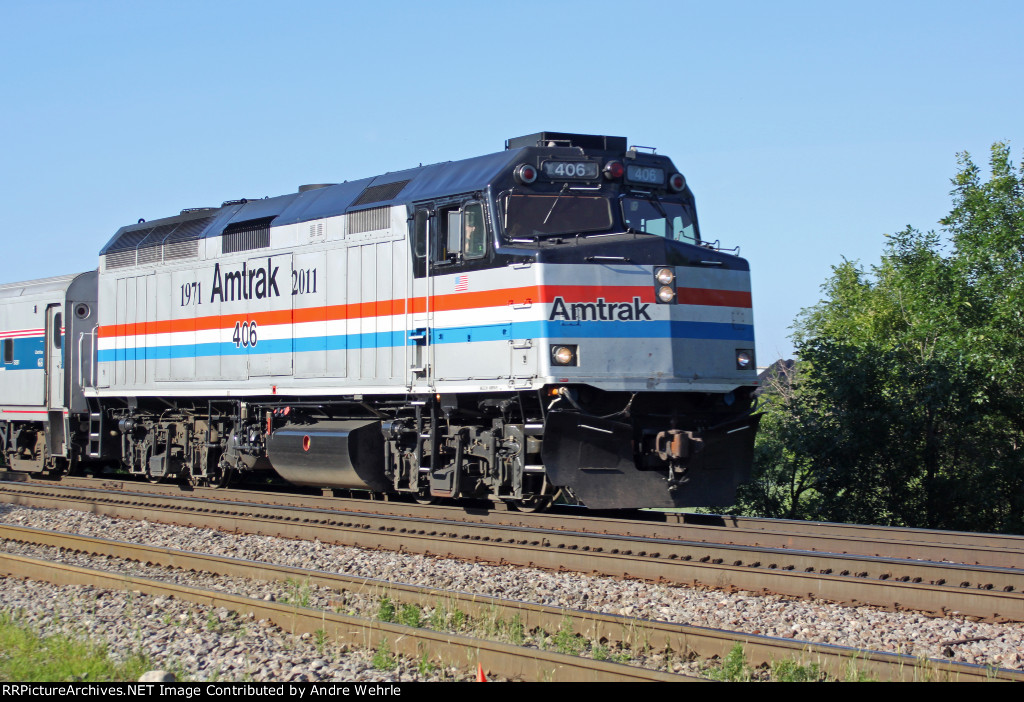 AMTK 406 glides along on the point of Hiawatha train 340 departing town